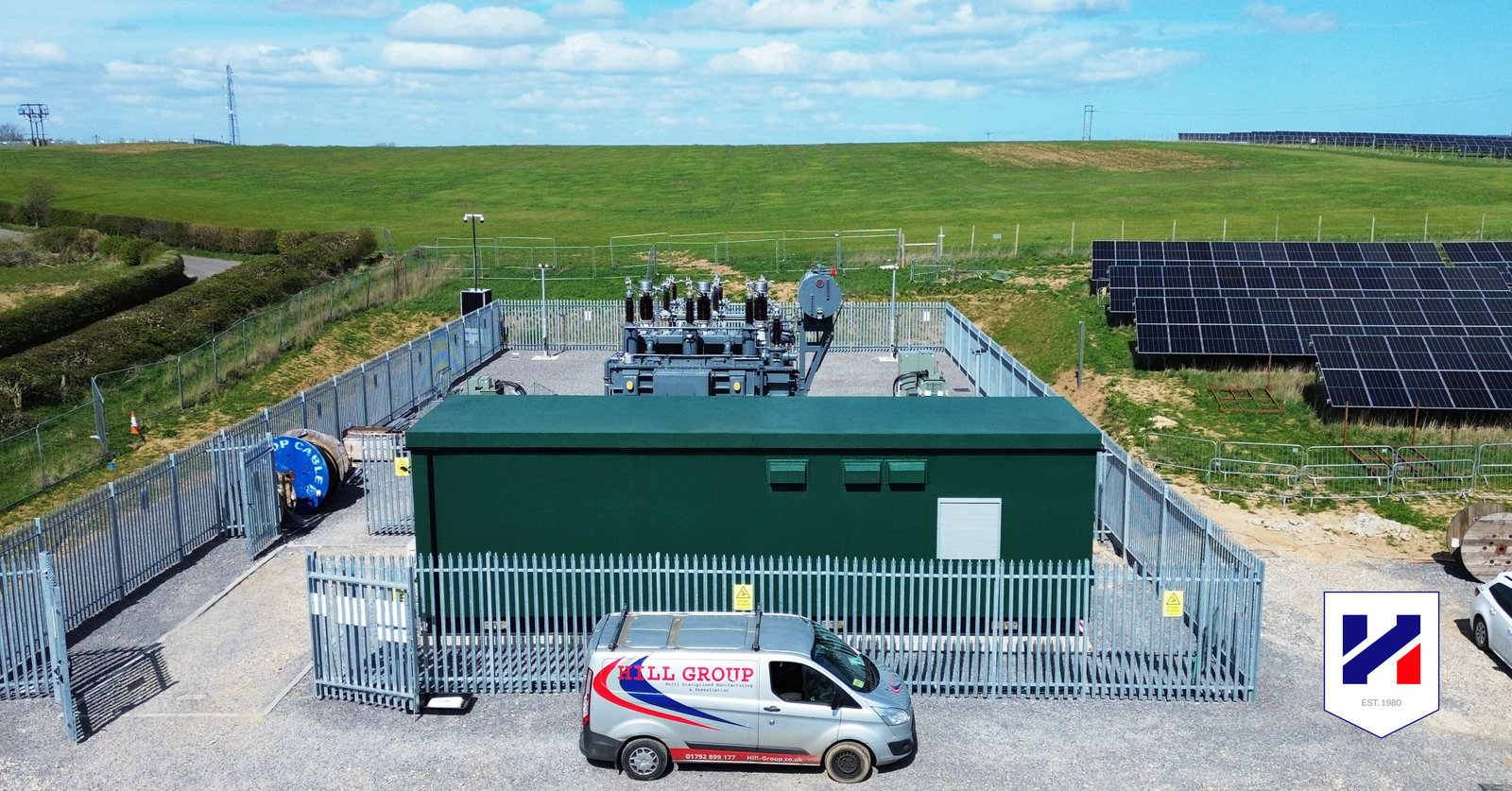 Aerial view of Hill Grwp Ltd's GRP enclosure compound with solar panels and van