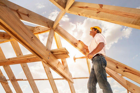 Construction worker on wooden roof framing enhancing energy efficiency in construction industry