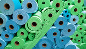 Collection of blue and green elastomeric foam rolls showcasing foam insulation options