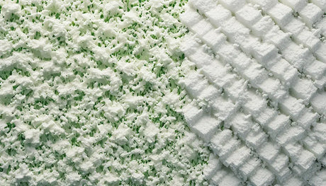 Textured surface contrasting snow-covered grass and patterned pavement illustrating foam board insulation.