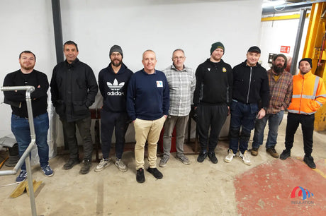 Group of nine men in trace heating training at Insulation & More