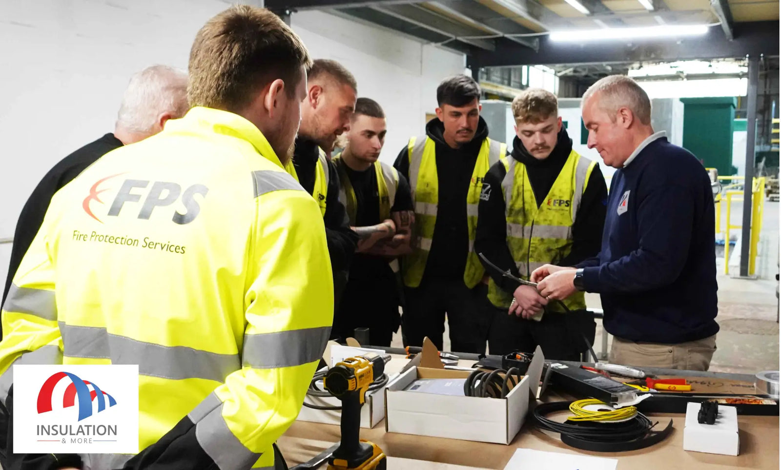 Yellow reflective safety vest with FPS logo in trace heating workshop by Fire Protect Services