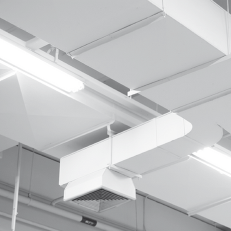 White ceiling-mounted ventilation and lighting fixtures installed on a gray industrial ceiling.